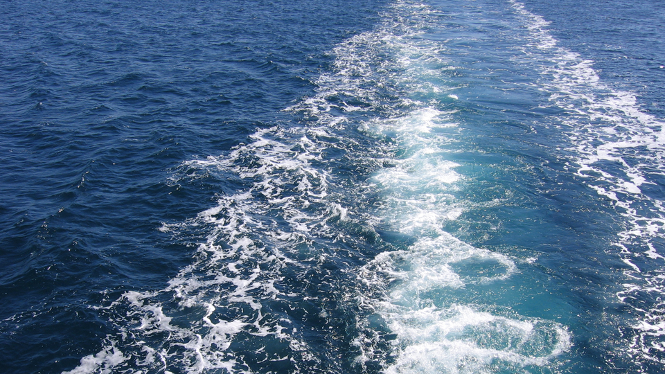 The image shows waves from a boat.